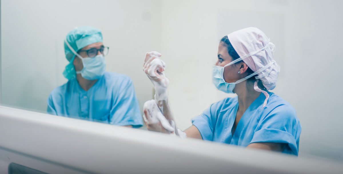 Doctors washing hands before operation.